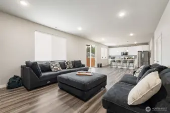 This kitchen-to-living layout keeps everyone part of the conversation, with a generous island, sleek finishes, and effortless flow into the great room.