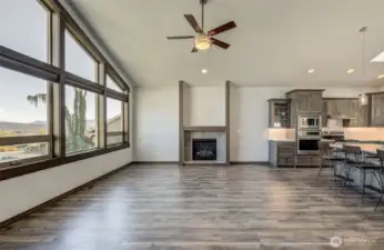 Expansive living room with floor-to-ceiling windows & a propane fireplace