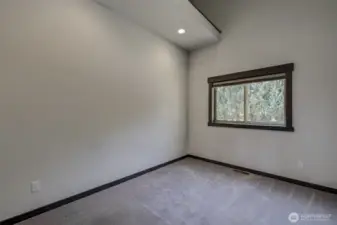 Second bedroom with modern fixtures and solid wood door detailing with LOFT storage.