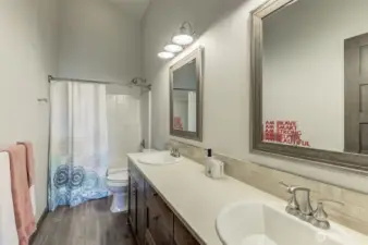 Upper-level full bathroom with modern tile, sleek vanity, and premium finishes.