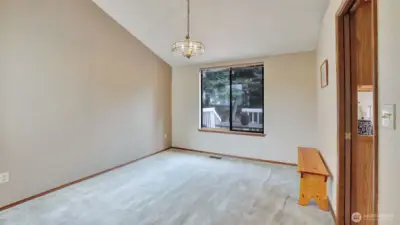 Formal dining room with vaulted ceilings.