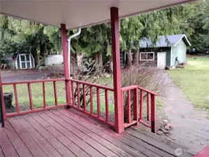 Gorgeous view from the living room, primary bedroom and another bedroom to peer out to the backyard which has two sheds, a lean to and loafing shed and the garage with shop.