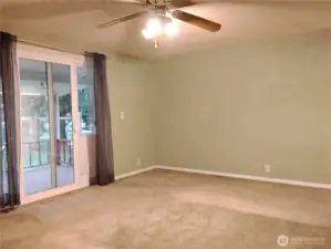 Primary bedroom with walk in closet.  Overhead fan light fixture.