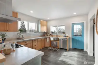 Kitchen with door to covered back porch and access to backyard