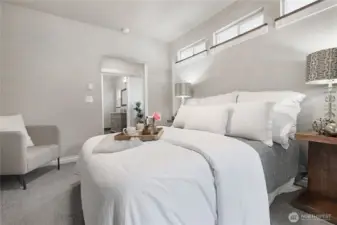 Primary bedroom with views into bathroom