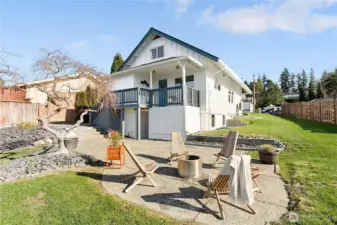 Backyard with patio area, with Japanese maple and apple tree