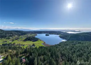 Breathtaking panoramic views of sparkling water, rolling hills, and lush forest create a stunning backdrop for your dream home in this truly one-of-a-kind setting.