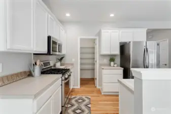 View into kitchen and walk in pantry.Newer stainless appliances that all stay.