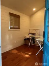 Home Office has custom ship lap walls, recessed lighting and wood laminate floors.