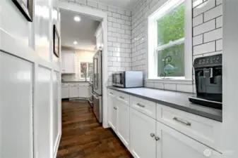 Serving kitchen/prep pantry with extra storage under the stairs