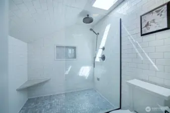 Primary 3/4 Baath with large walk-in shower with Carrara marble floor tiles, built-in bench & skylight.