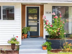 Inviting front stoop with new craftsman style door offers a warm welcome for friends and guests.
