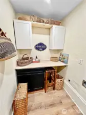 Main floor laundry room complete with folding counter and cabinet storage.