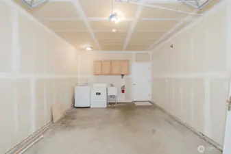 Attached garage with laundry area and storage options
