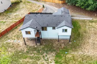 Aerial view showcasing the spacious backyard and roofline