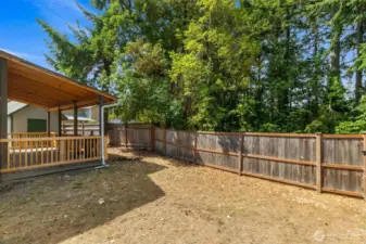 Fully fenced yard backs to a lake.