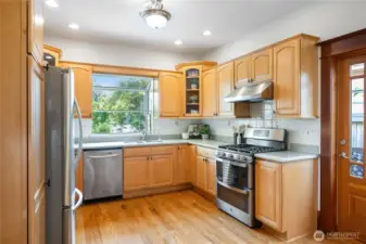 eat-in kitchen overlooks back yard and has side door access