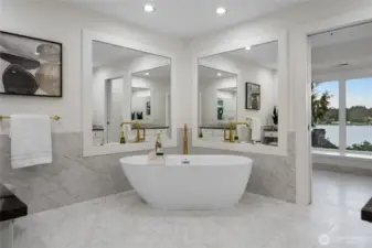 The large soaking tub is the star of the recently updated spa-like ensuite primary bathroom