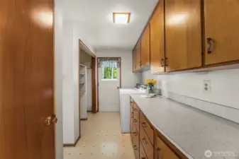 Utility room/mud room features door to back yard.