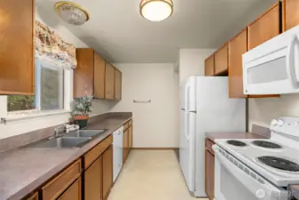 Plenty of storage in this kitchen.  At the end, there's another entrance to the bathroom and bedrooms