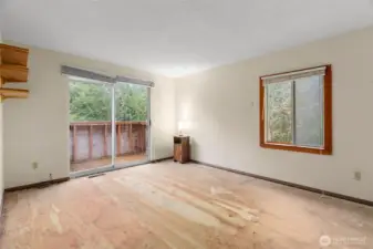 Primary bedroom with its own private deck with slider door