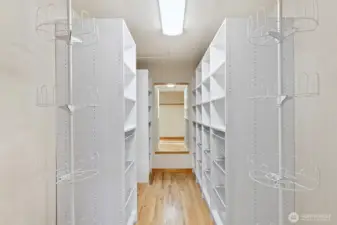 Large walk-in closet with built-in shelving and ample storage.