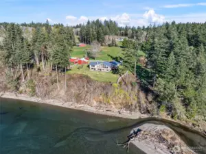 Private 800-foot beachfront with uninterrupted water views, showcasing the estate’s unparalleled waterfront setting.