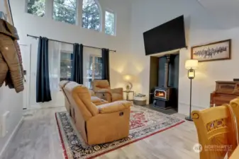 Living area with tall ceilings and wood burning stove