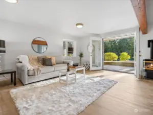 Loads of light floods in this lower level great room with propane stove. Look at this beam!