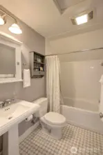 The upstairs hall baths has a tile floor and tile shower surround.