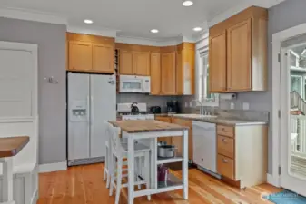 The kitchen counters are granite and the propane range is perfect for the stormy nights when the power goes out and you need to cook.  Off the kitchen/living space is a door to the front porch.