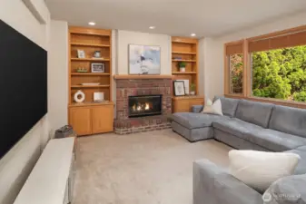 A roomy family room, made extra cozy with a wood-burning fireplace.