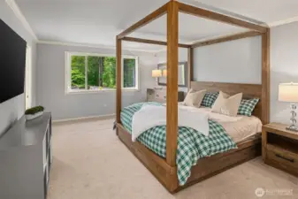A roomy primary suite, offering views of the serene backyard.