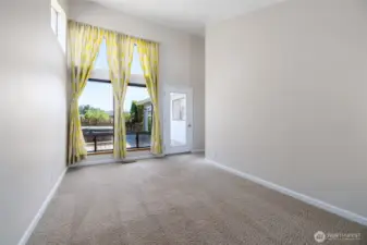 Corner bedroom with a floor to ceiling window. Door leads to the deck w/hot tub.