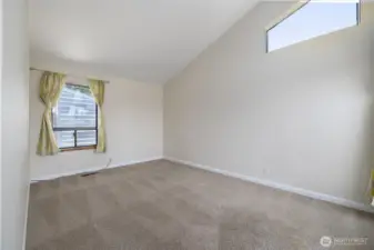 The corner bedroom has plenty of light and architectural elements that make the room visually appealing.