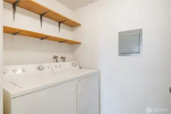 Laundry room with storage shelving