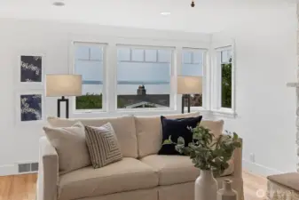 A bank of west-facing windows takes full advantage of natural light and frames colorful evening sunsets, filling the living room with warmth and glow.