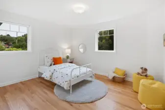 The second main floor bedroom is bright and cheerful, with dual windows bringing in abundant natural light.