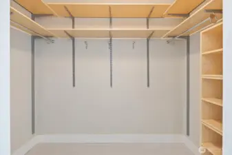 The primary suite is complete with dual walk-in closets—designed so both partners have their own spacious storage.