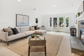 Freshly painted and newly carpeted, this spacious family room offers a warm and inviting retreat. A gas fireplace anchors the room, while large windows and glass doors provide natural light and direct access to the backyard—perfect for seamless indoor-outdoor living.