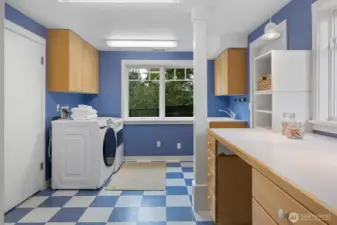 Spacious and versatile, the laundry room includes backyard access, ample cabinetry, and a generous counter that doubles as a folding station or a secondary work-from-home space.