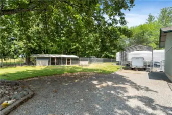 This pictures shows the fully fenced and covered poultry or small animal raising area, and additional small open covered storage area.