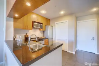 Timeless kitchen with stainless appliances and separate pantry.