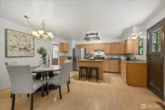 Large kitchen with eating space, breakfast bar & access to private deck.