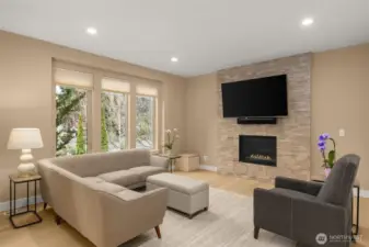 Sun filled living space with stone fireplace