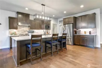 The chef’s kitchen boasts top-of-the-line appliances, a generous island, and exceptional workspace—perfect for everyday living and entertaining.