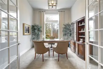 A private den with French doors offers the perfect home office or library.