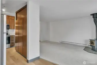 From noon looking at kitchen on left and living room with cozy fireplace on right