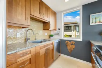 Stunning, real wood cabinetry, granite counters and beautiful tile backsplash.