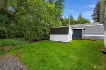 Private back yard with storage, you can even hear the creek behind the trees